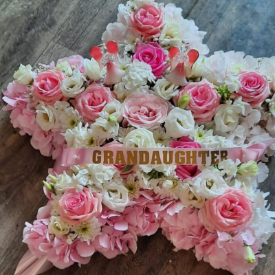 Star of Love Tribute - A star-shaped tribute filled with delicate pinks and whites, offering a tender expression of love and remembrance. Ideal for honouring a beloved family member or friend.