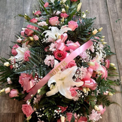 Graceful Pink Tribute - A lovely spray arrangement combining soft pink and white flowers, beautifully tied with a pink ribbon. This tribute conveys a message of grace, love, and remembrance.