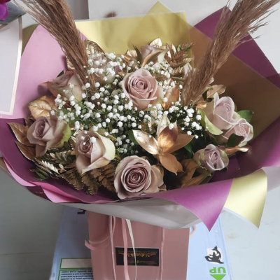 Rose Gold Dreams Bouquet - This arrangement features muted tones of beige and blush roses, enhanced with gypsophila and golden accents. The rose gold elements bring a modern twist to a classic bouquet, making it a stunning gift