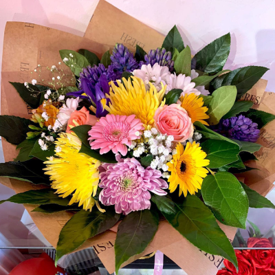 Bright Blossoms Bouquet - A cheerful bouquet filled with vibrant flowers in a mix of yellow, pink, purple, and white. Perfect for bringing a burst of colour and joy to any occasion.